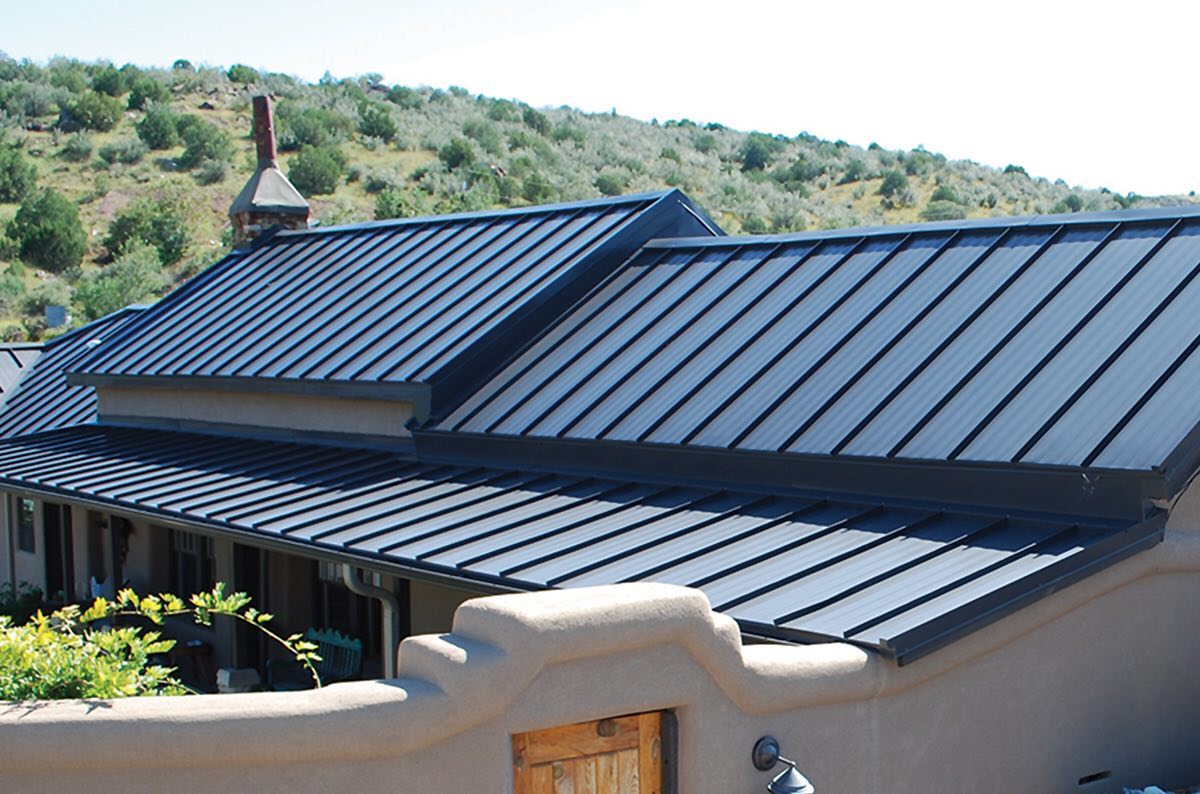 black metal rooftop with treed hills in background