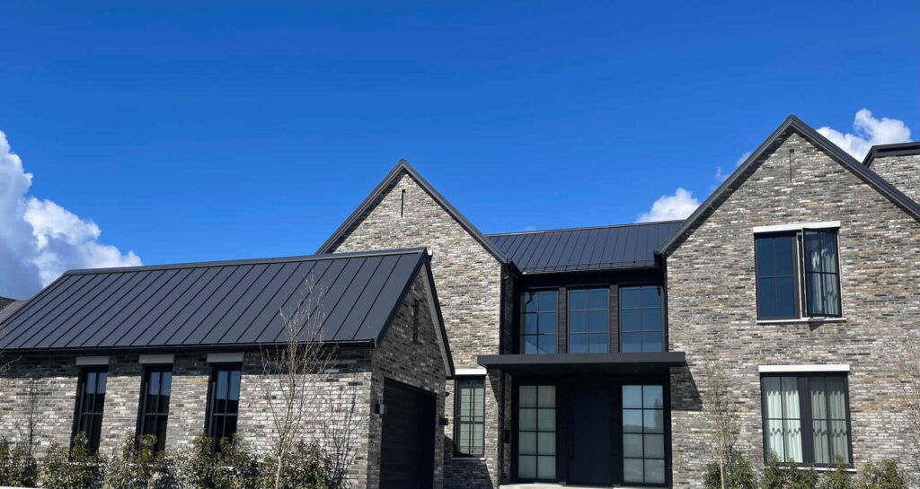 Black metal roof on stone house