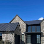 Black metal roof on stone house