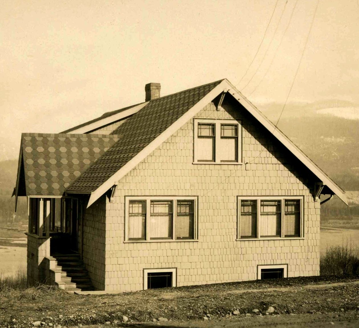 Early 1900s British Columbia home featuring a checker-patterned ashphalt roof