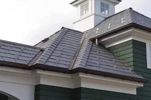 Rooftop of home featuring enviroslate roofing and snow guards